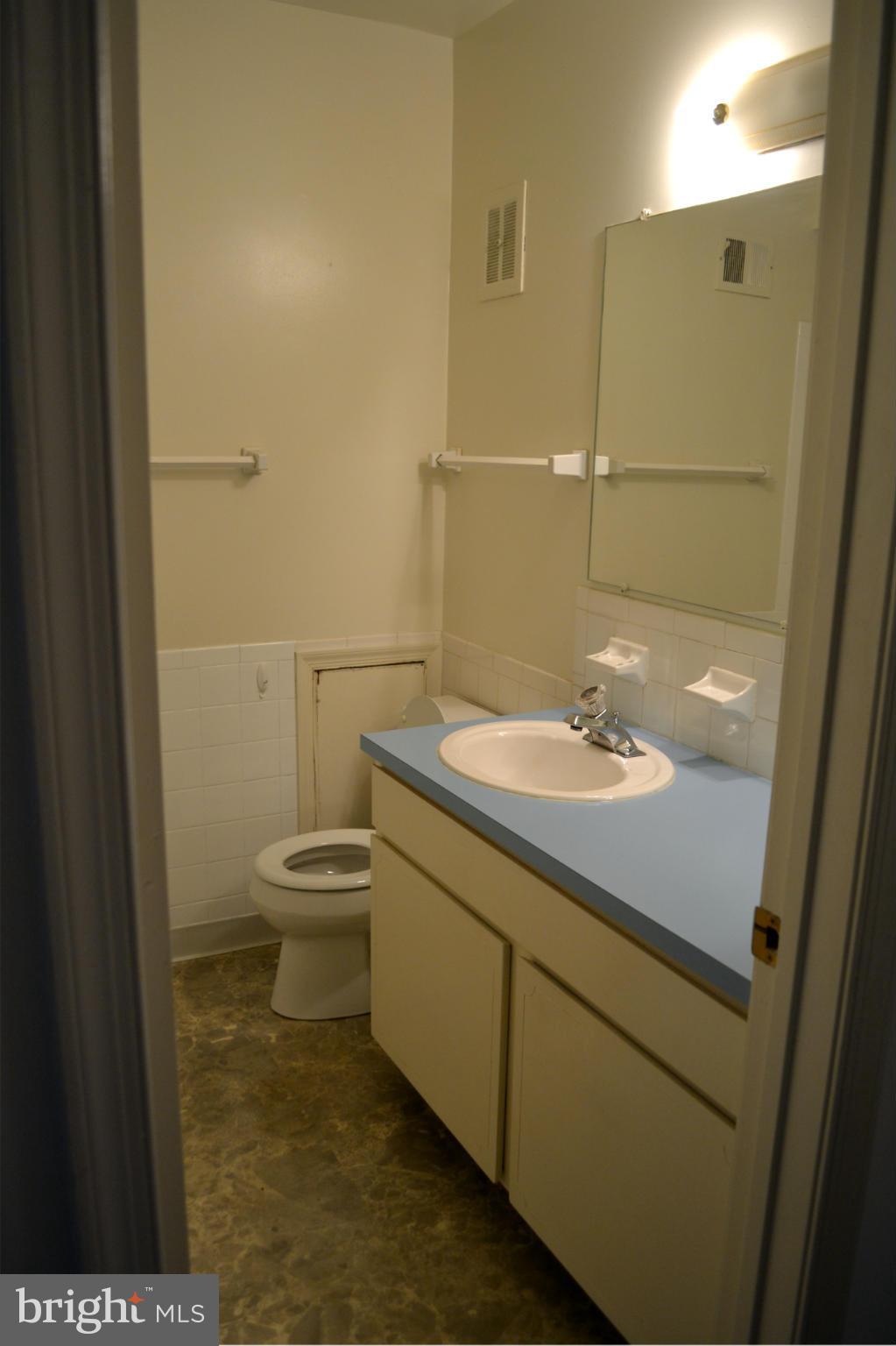8256 Carrleigh Parkway Springfield, VA 22152 - Photo 19 of 28 a bathroom with a sink a toilet and shower