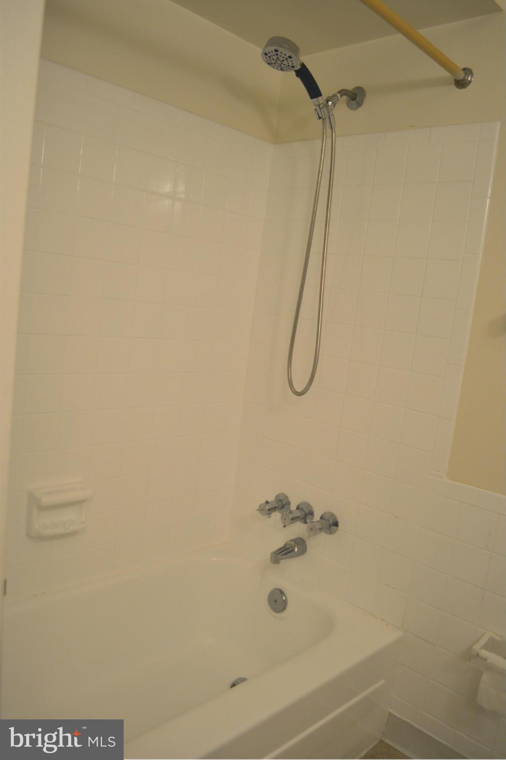 8256 Carrleigh Parkway Springfield, VA 22152 - Photo 20 of 28 a bathroom with a bath tub with a shower