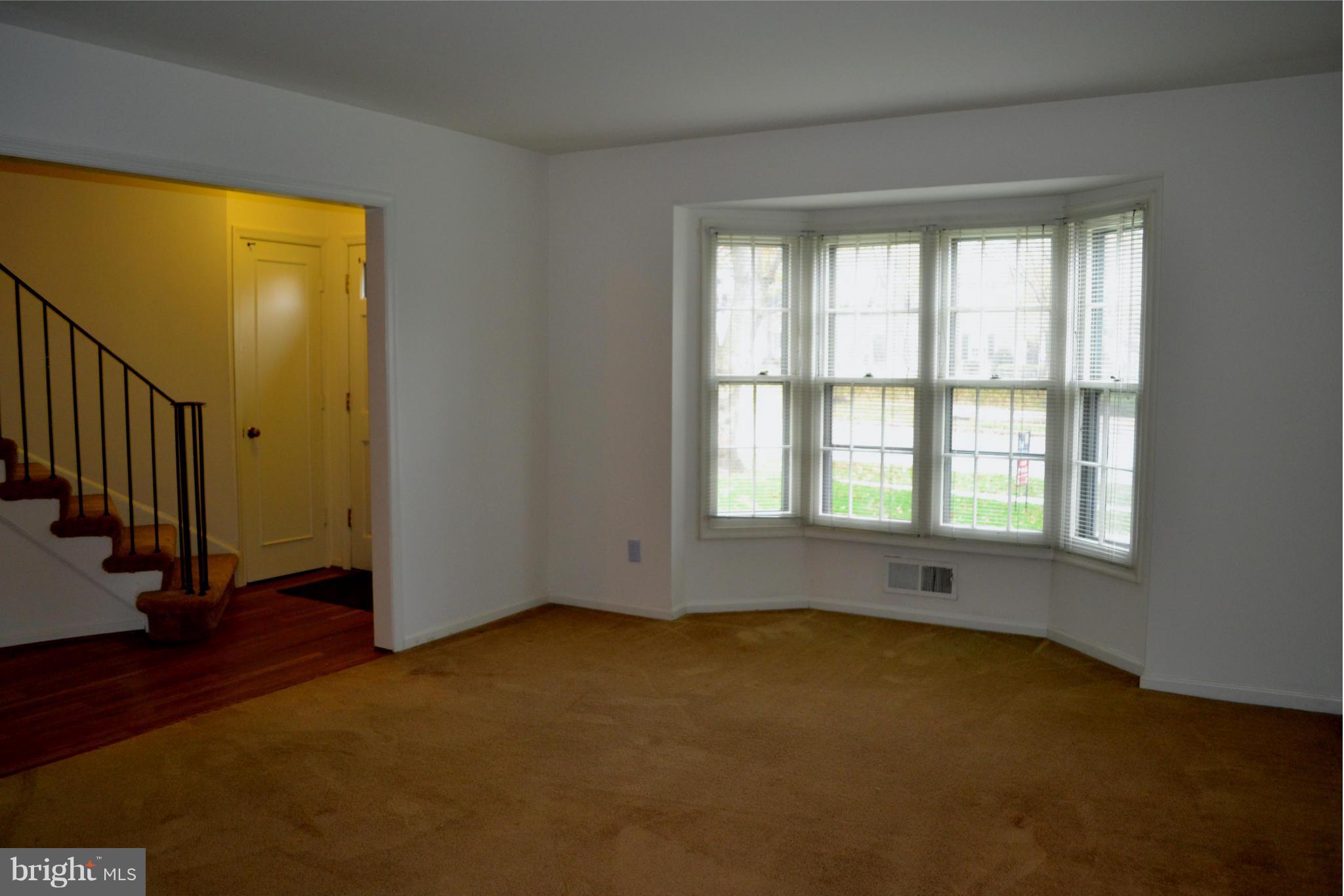 8256 Carrleigh Parkway Springfield, VA 22152 - Photo 4 of 28 a view of an empty room with wooden floor and a window
