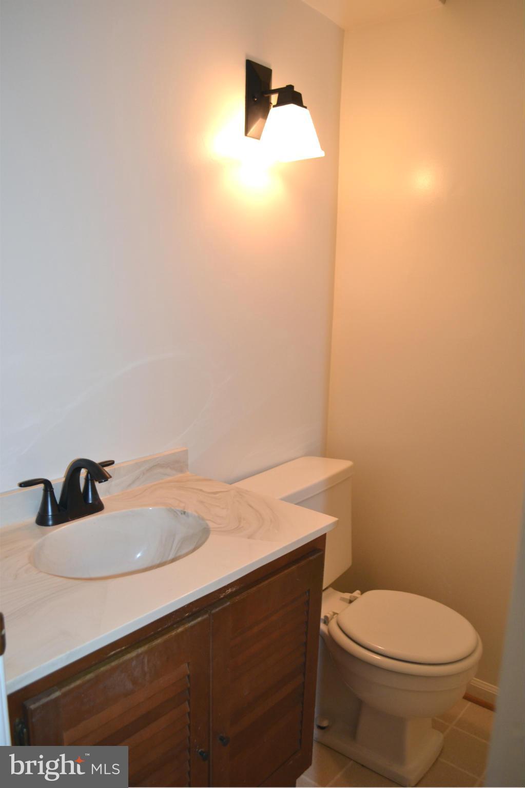 8256 Carrleigh Parkway Springfield, VA 22152 - Photo 7 of 28 a bathroom with a sink a toilet and vanity
