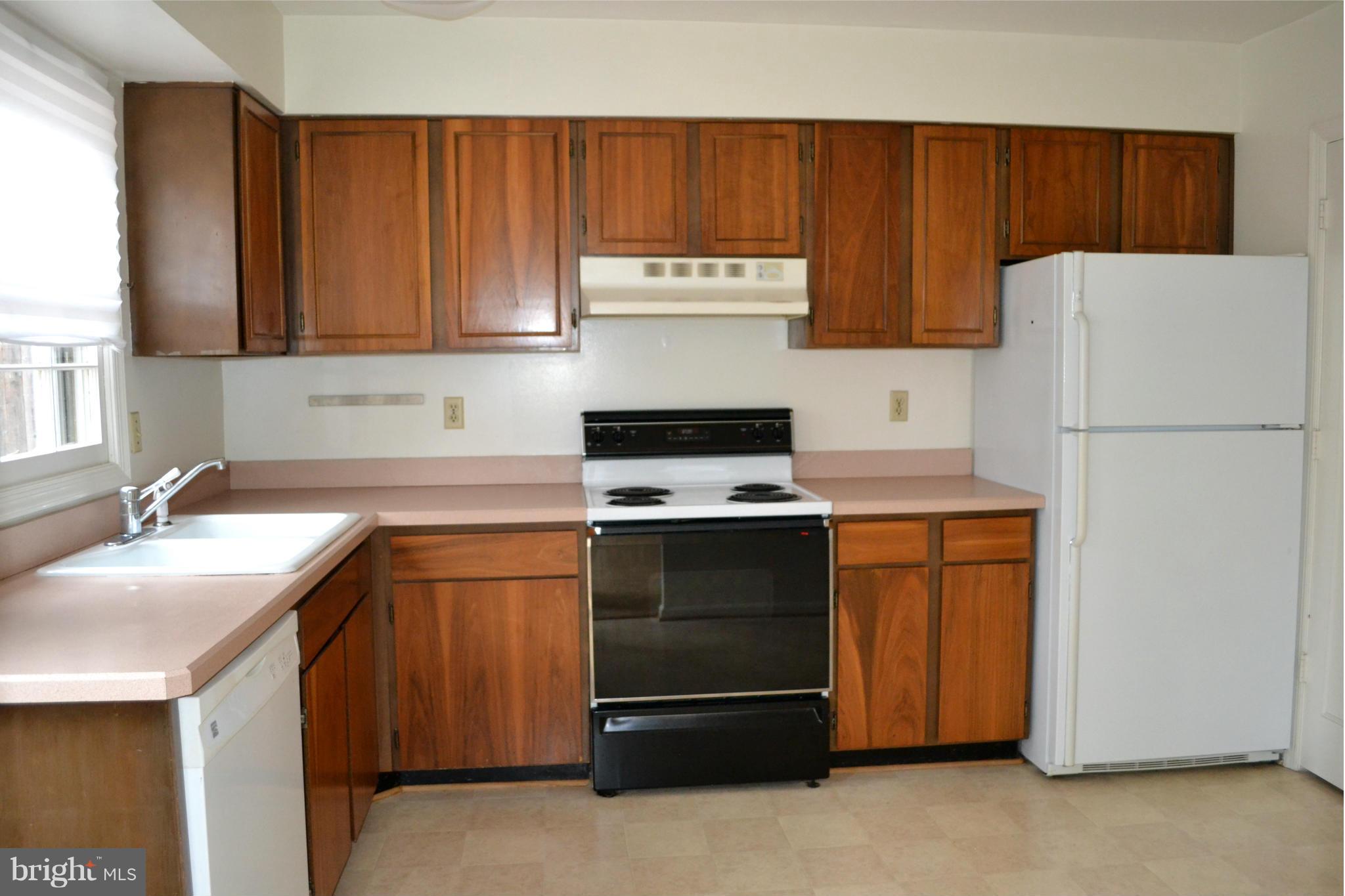 8256 Carrleigh Parkway Springfield, VA 22152 - Photo 8 of 28 a kitchen with a sink and a refrigerator