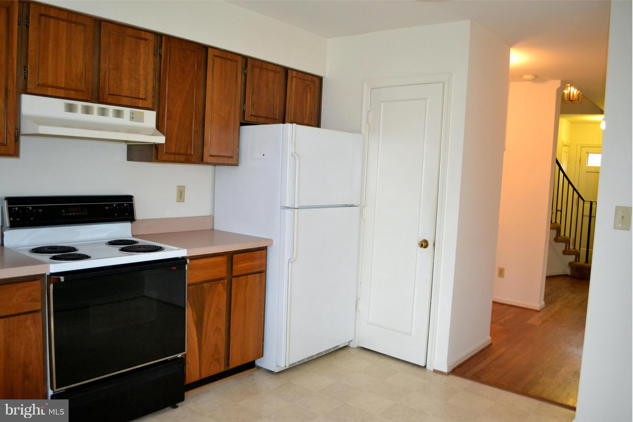 8256 Carrleigh Parkway Springfield, VA 22152 - Photo 9 of 28 a kitchen with a stove and a refrigerator