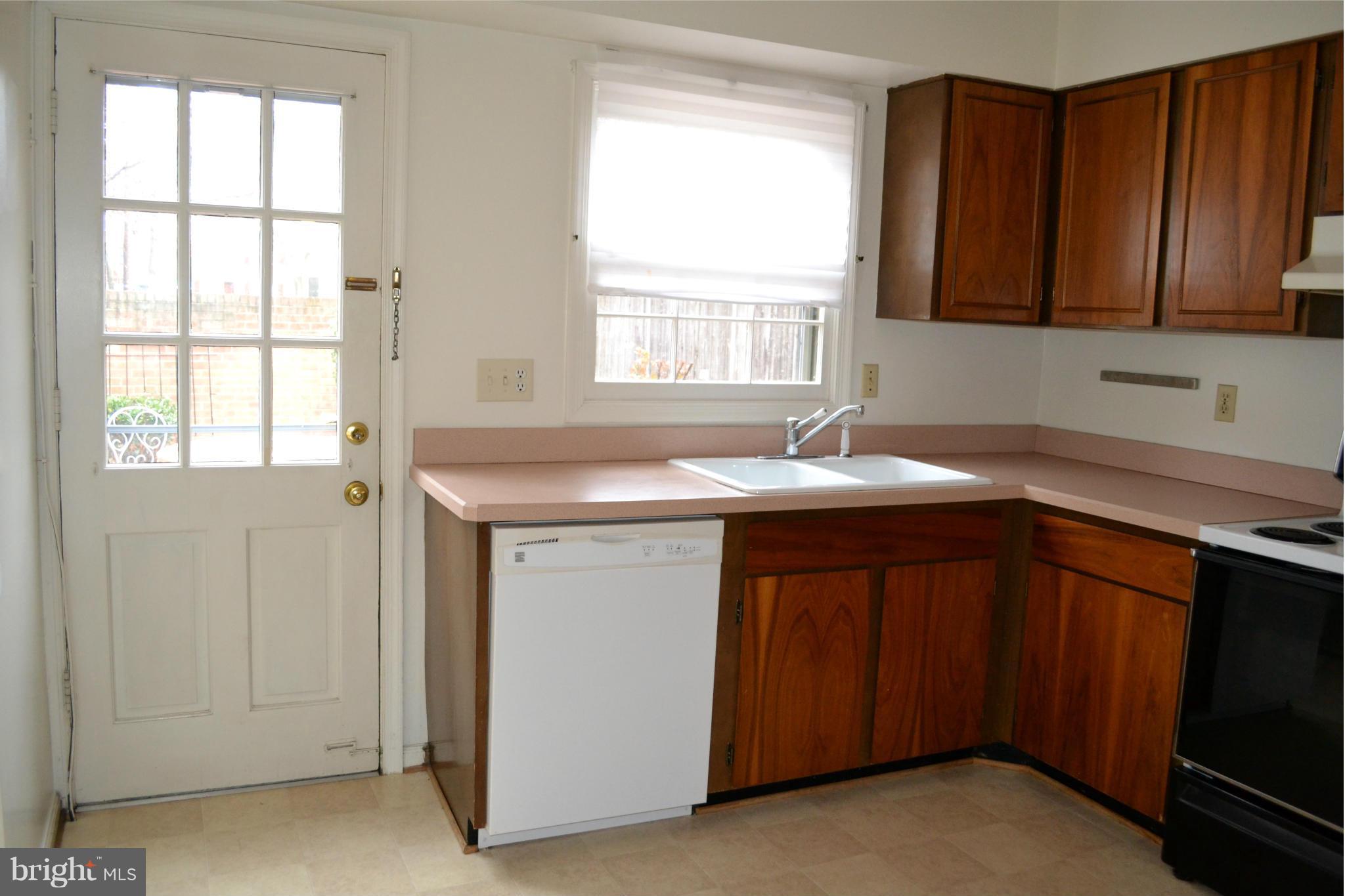 8256 Carrleigh Parkway Springfield, VA 22152 - Photo 10 of 28 a utility room with a sink cabinets and a window