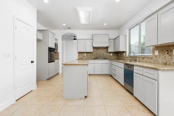 a kitchen with a refrigerator a sink and cabinets