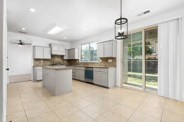 an empty room with windows and fireplace