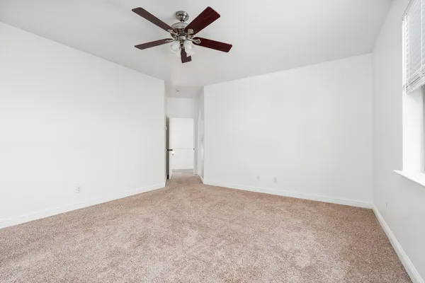 a spacious bathroom with a granite countertop sink and a mirror