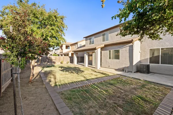 a view of small yard and wooden fence