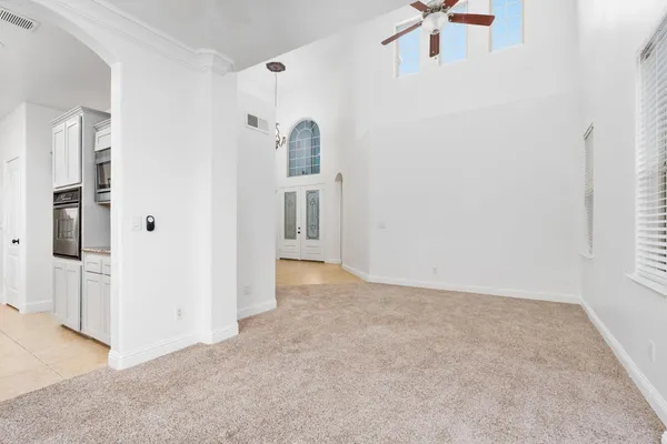 an empty room with windows and cabinet
