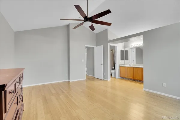 a view of an empty room with a ceiling fan