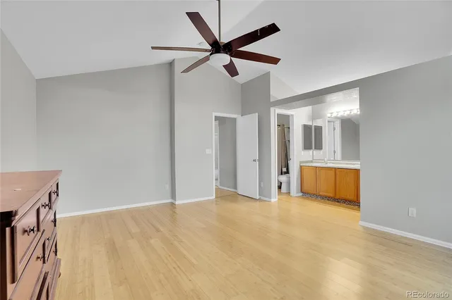 a view of an empty room with a ceiling fan