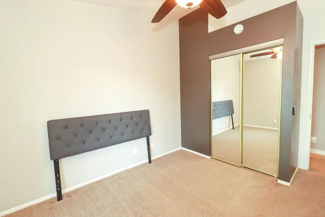 a view of a room with a ceiling fan