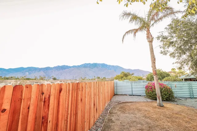 a front view of a house with a yard and a garage