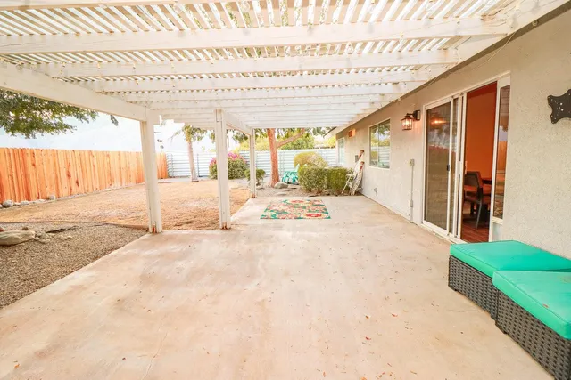 a kitchen with a sink and chairs