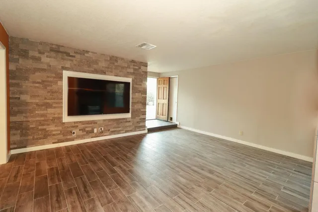 wooden floor in an empty room with a fireplace