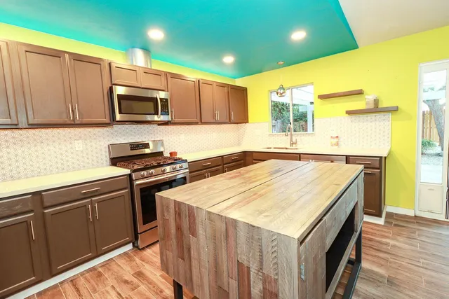 a kitchen that has a sink and a stove top oven