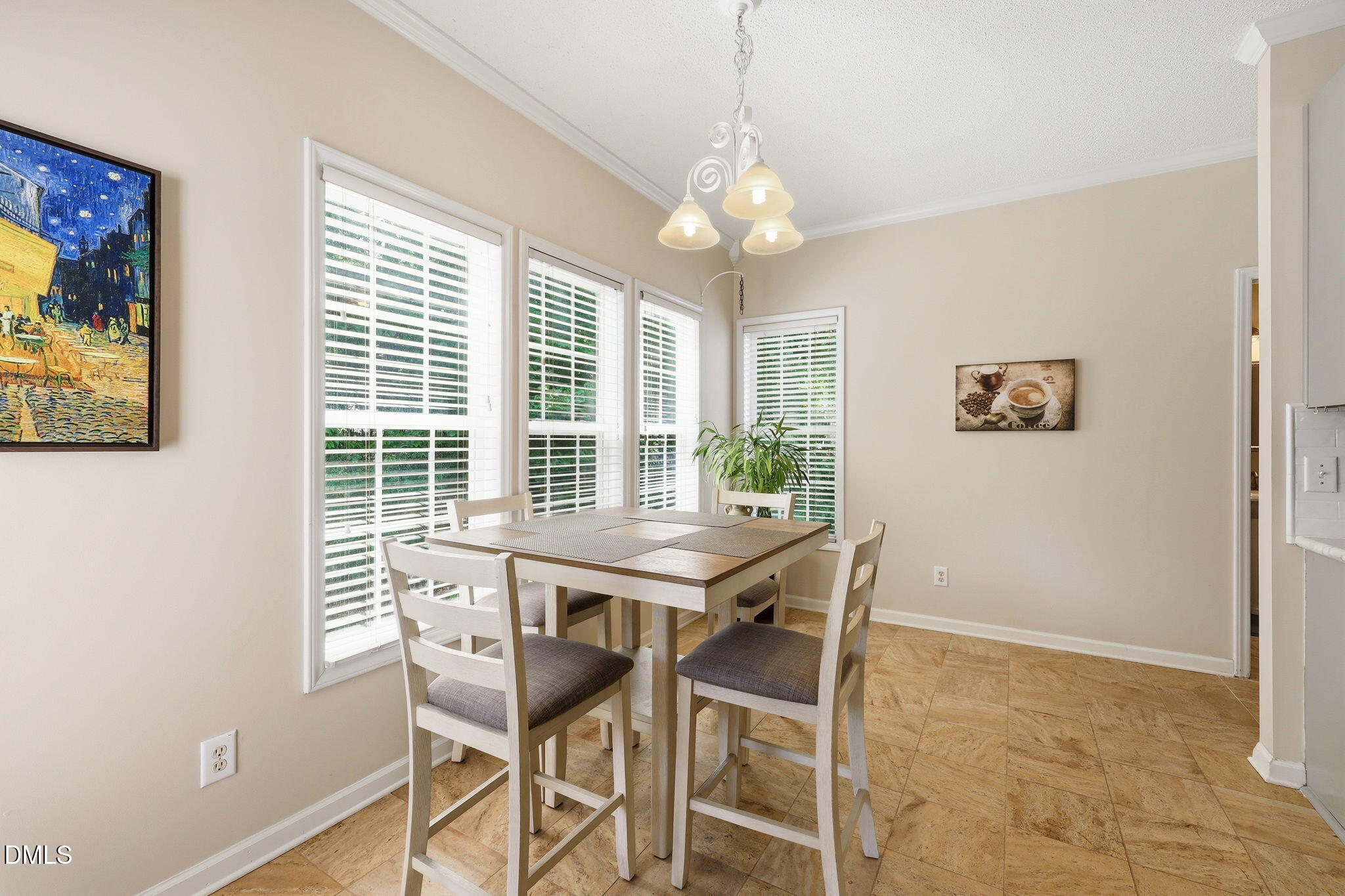 9105 Willow Valley Court Raleigh, NC 27617 - Photo 16 of 51 a view of a dining room with furniture large window and wooden floor