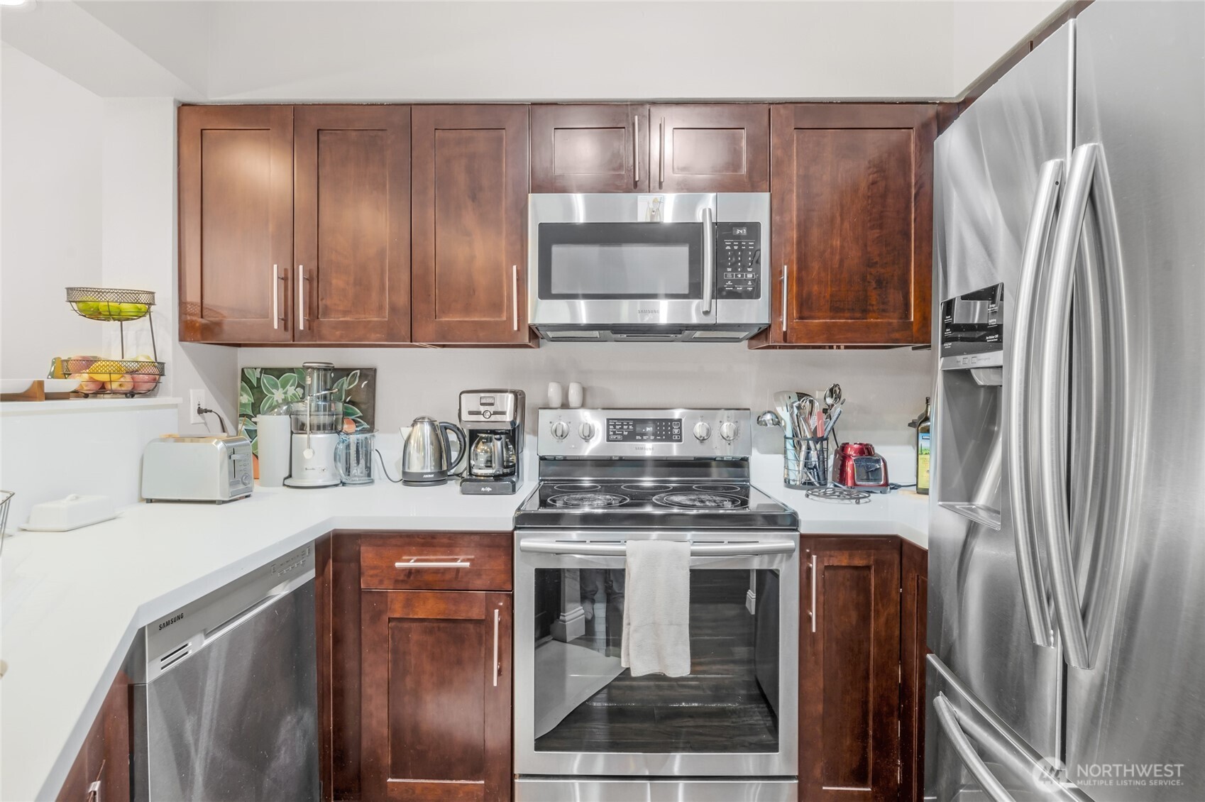 15300 112th Avenue Northeast, Unit A304 Bothell, WA 98011 - Photo 12 of 28 a kitchen with stainless steel appliances granite countertop a refrigerator stove and sink