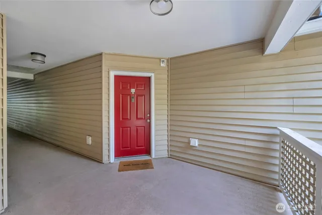 a view of a room with door and white walls