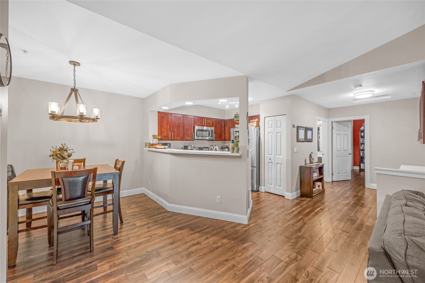 15300 112th Avenue Northeast, Unit A304 Bothell, WA 98011 - Photo 6 of 28 a view of a dining room and livingroom with furniture wooden floor a chandelier