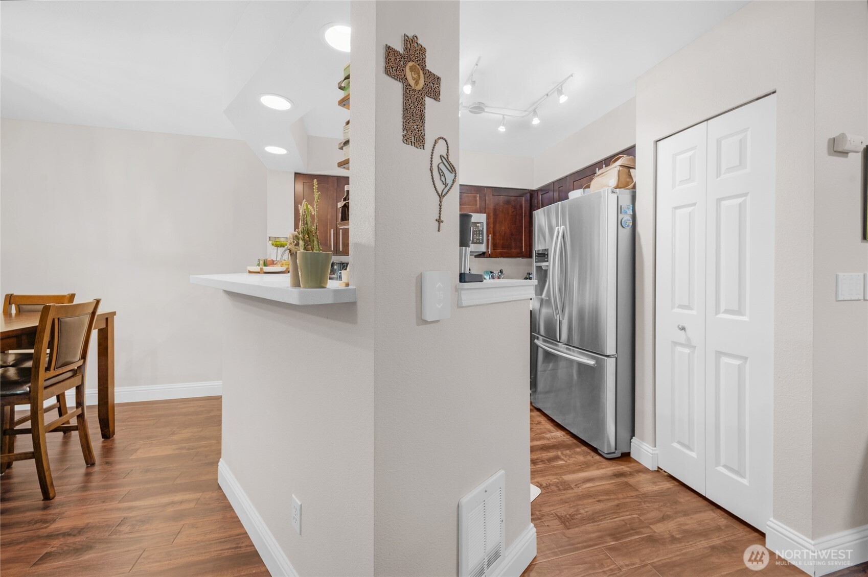 15300 112th Avenue Northeast, Unit A304 Bothell, WA 98011 - Photo 7 of 28 a kitchen with stainless steel appliances a refrigerator and wooden floor