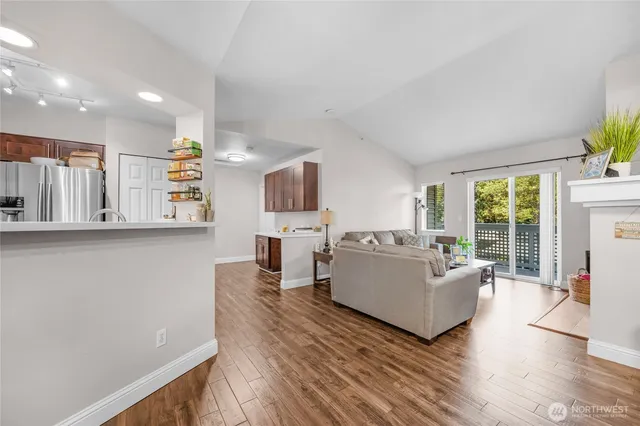 a living room with fireplace furniture and a wooden floor