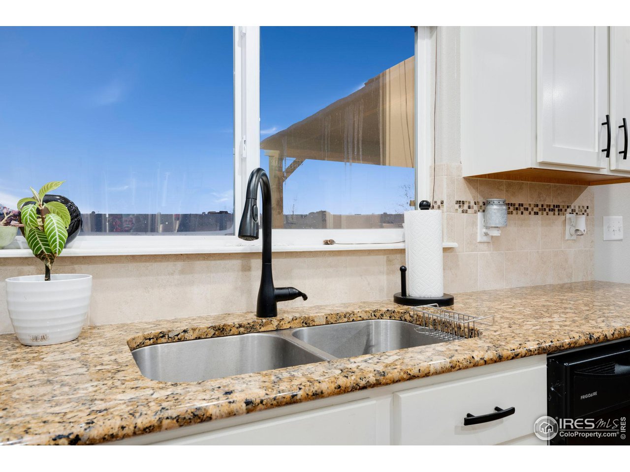 7334 23rd St Road Greeley, CO 80634 - Photo 13 of 31 a kitchen with a sink and a cabinets
