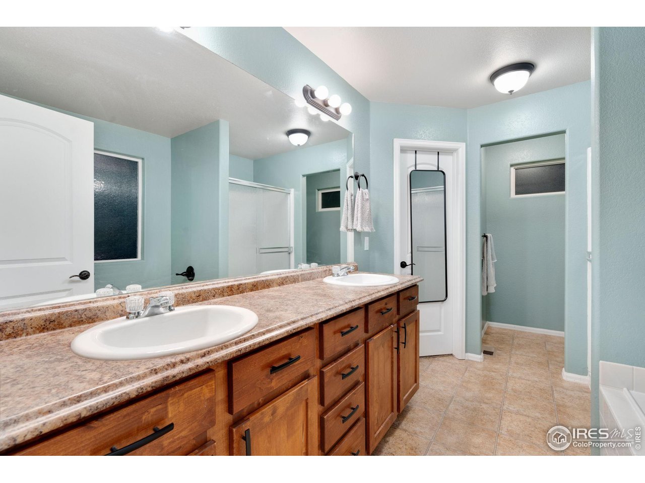 7334 23rd St Road Greeley, CO 80634 - Photo 18 of 31 a bathroom with a granite countertop sink and a mirror
