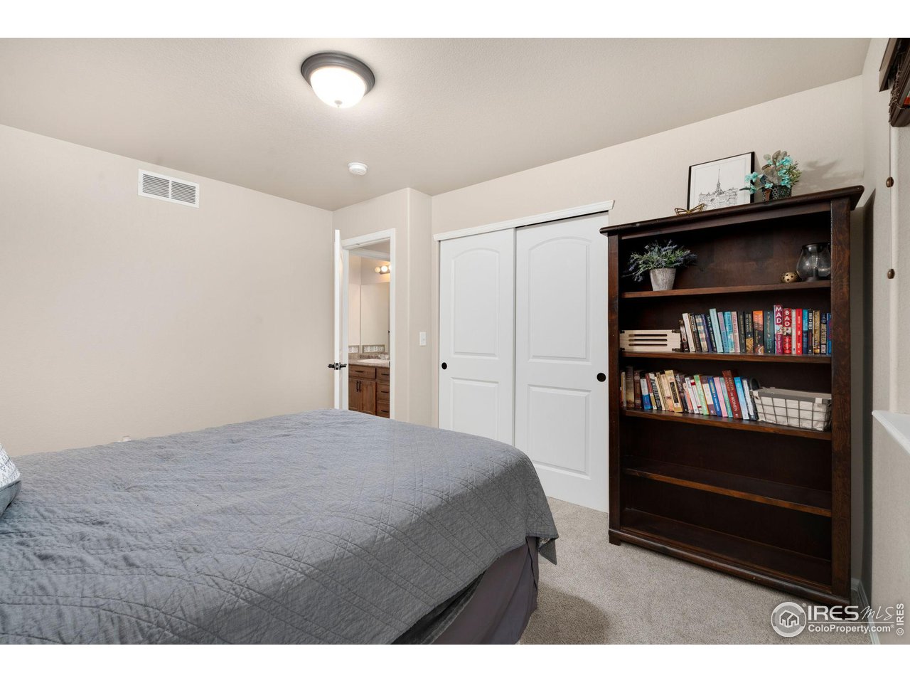 7334 23rd St Road Greeley, CO 80634 - Photo 23 of 31 a bedroom with a bed and a book shelf