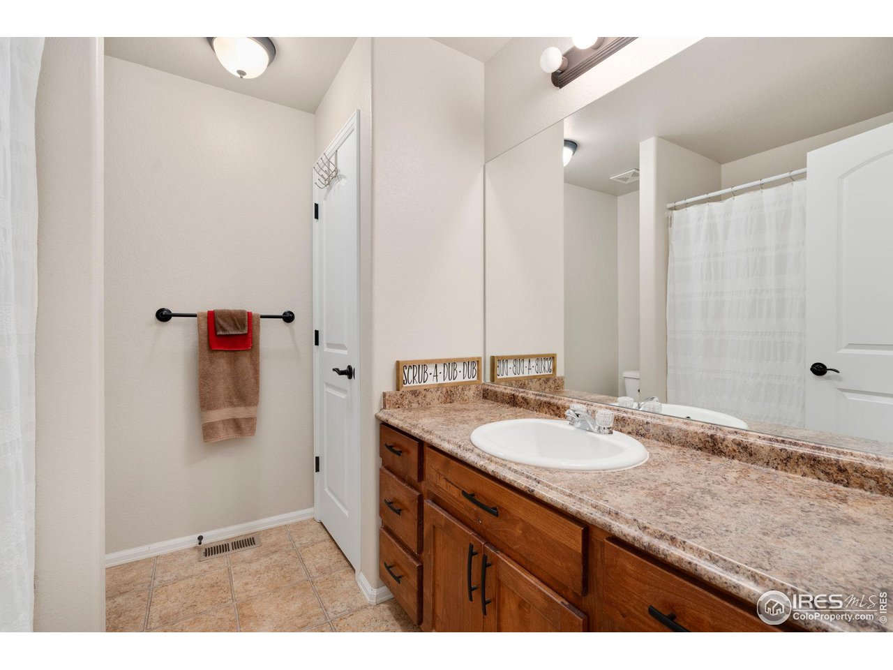 7334 23rd St Road Greeley, CO 80634 - Photo 25 of 31 a bathroom with a granite countertop sink mirror and double