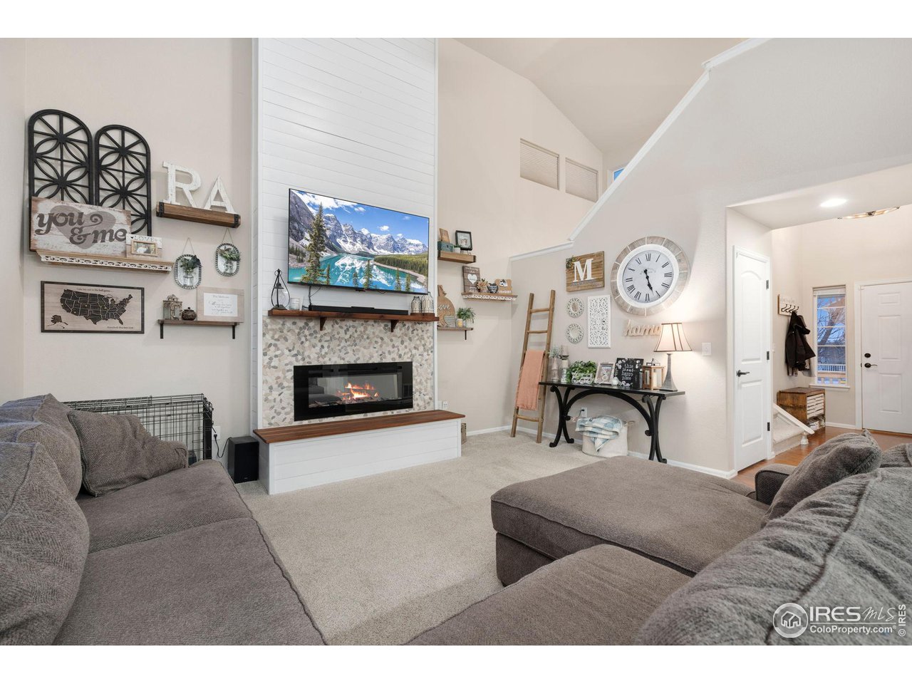 7334 23rd St Road Greeley, CO 80634 - Photo 7 of 31 a living room with furniture a flat screen tv and a fireplace