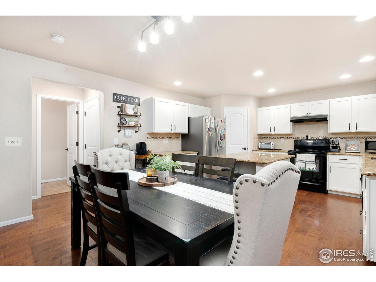 7334 23rd St Road Greeley, CO 80634 - Photo 8 of 31 a kitchen with stainless steel appliances kitchen island granite countertop a dining table chairs and view living room