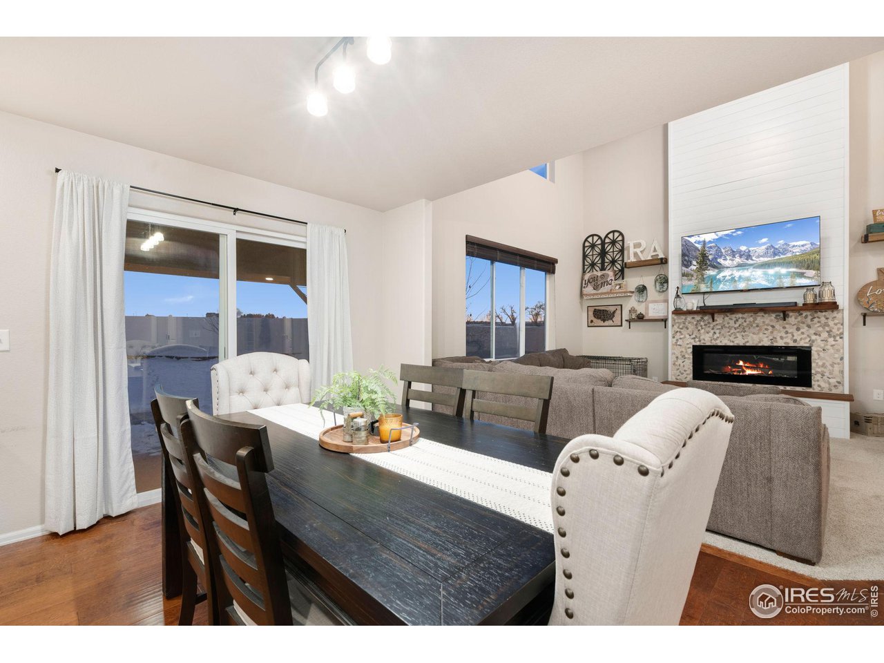 7334 23rd St Road Greeley, CO 80634 - Photo 9 of 31 a living room with furniture wooden floor and a fireplace