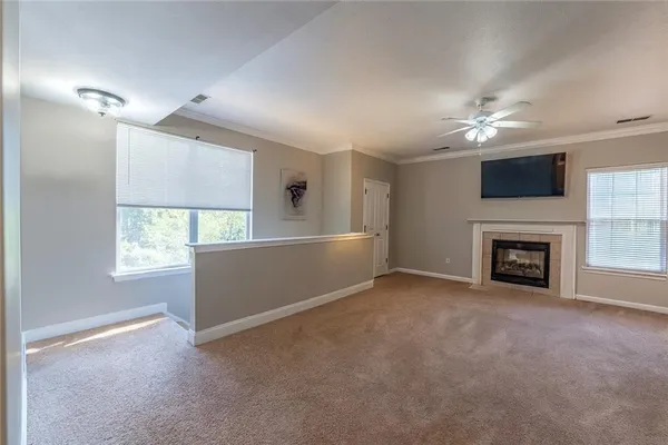 a view of a livingroom with a fireplace and window