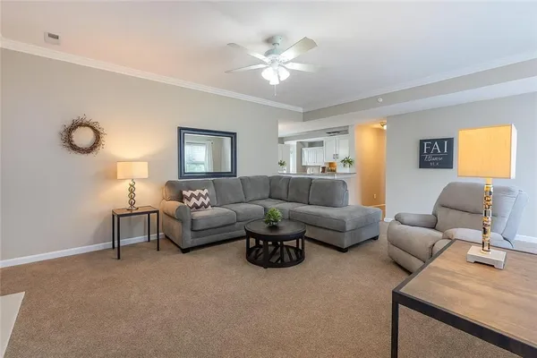 a living room with furniture a chandelier and a window
