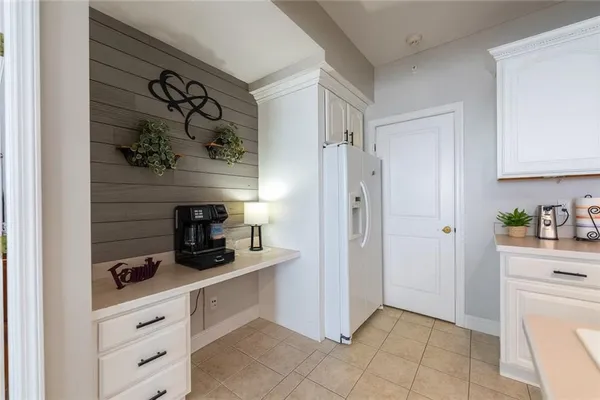 a kitchen with a refrigerator and cabinets