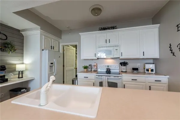 a kitchen with stainless steel appliances a refrigerator sink and cabinets