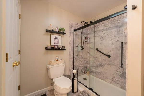 a bathroom with a toilet and shower