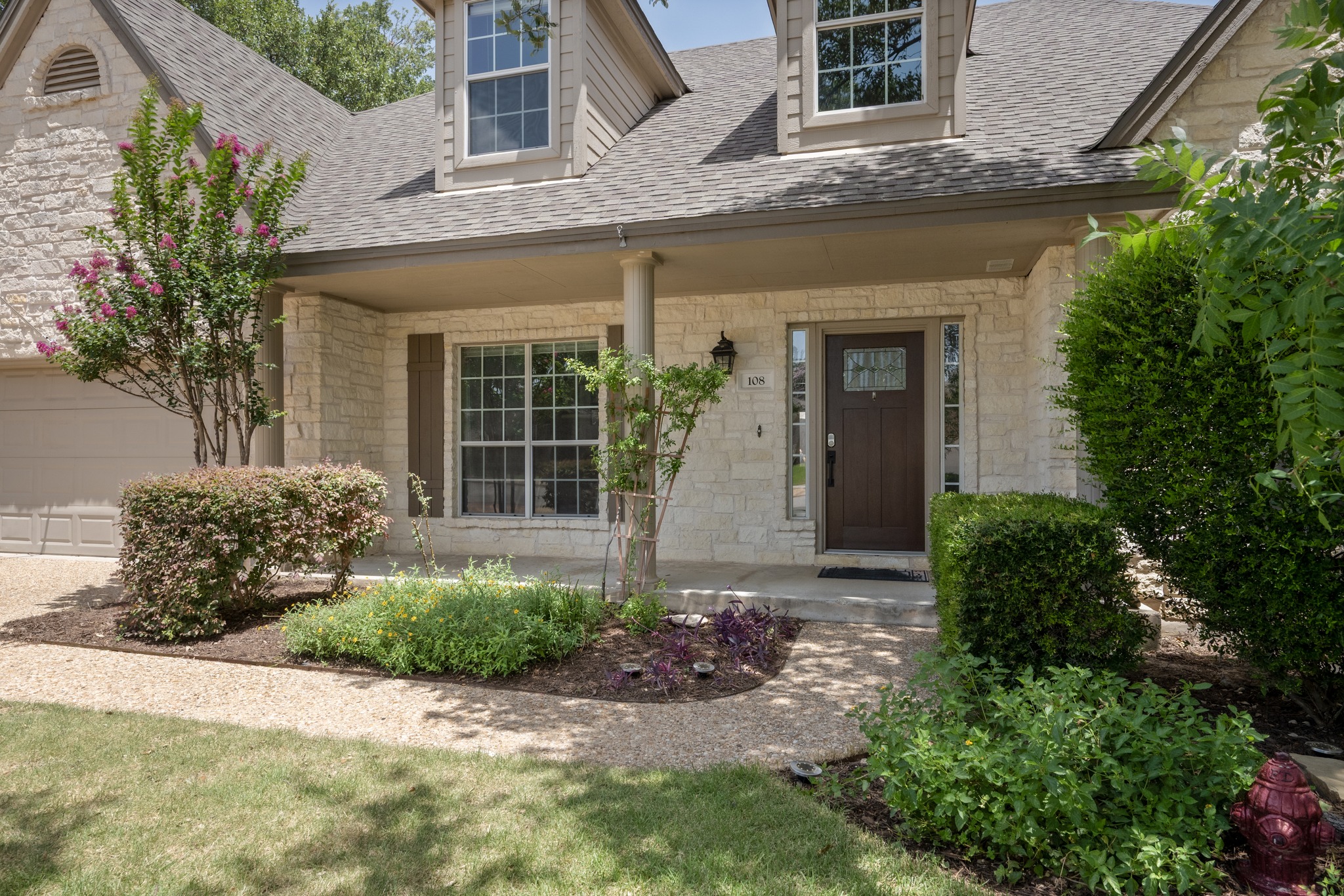108 Thornwood Road Georgetown, TX 78628 - Photo 3 of 40 A well-maintained facade with charming stonework and inviting landscaping welcomes you home.