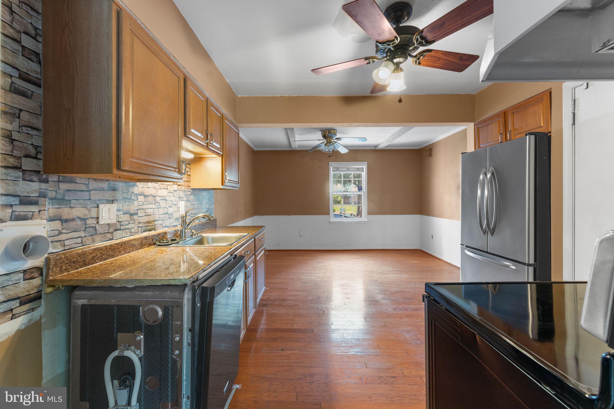 14489 Golden Oak Road Centreville, VA 20121 - Photo 5 of 27 a kitchen with a sink a refrigerator and cabinets