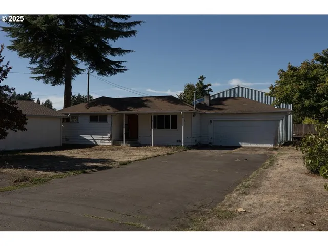 a yellow house with trees in front of it