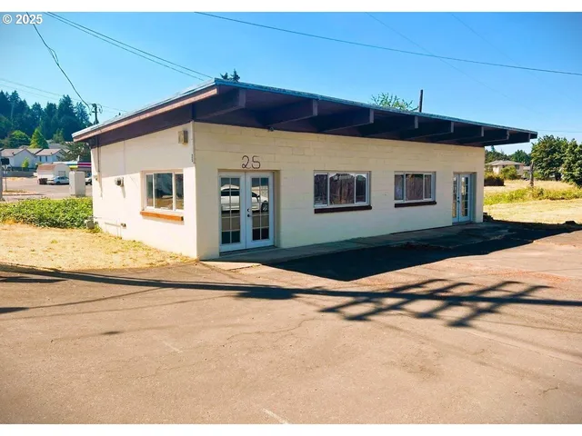 a white house that has a tree in front of it