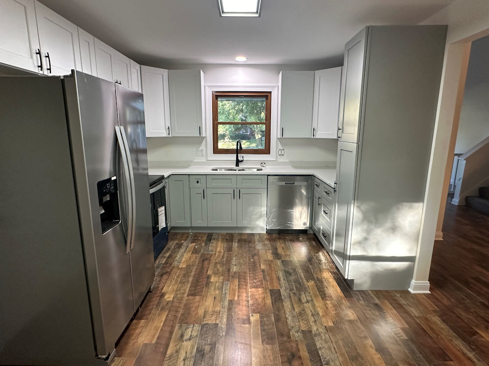 1246 Springdale Drive Rochelle, IL 61068 - Photo 2 of 9 a kitchen with kitchen island wooden floor refrigerator and sink