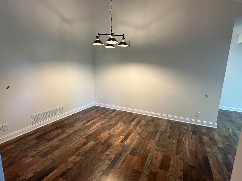 1246 Springdale Drive Rochelle, IL 61068 - Photo 6 of 9 a view of a room with wooden floor and air conditioner