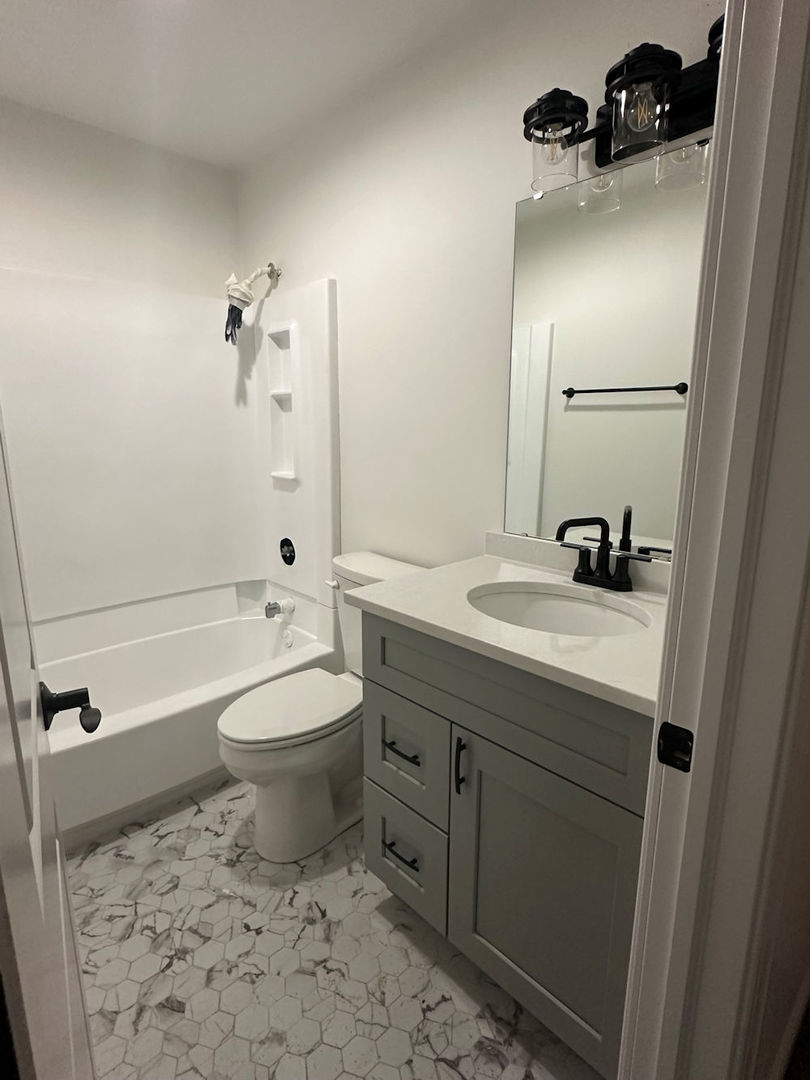 1246 Springdale Drive Rochelle, IL 61068 - Photo 9 of 9 a bathroom with a sink a toilet and shower