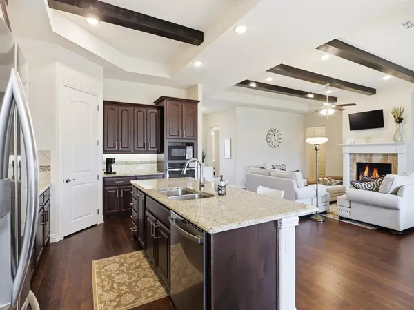 a kitchen with a sink appliances and cabinets