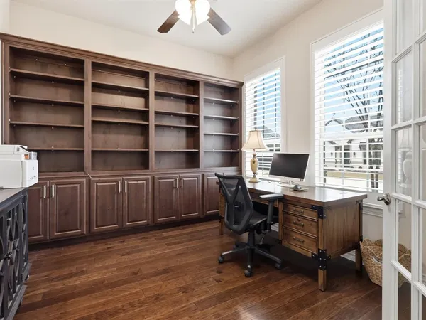 a view of a workspace with furniture and a window