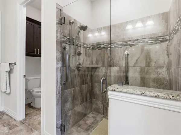 a bathroom with a shower a toilet and a sink