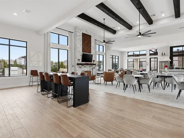 a living room with lots of furniture a wooden floor and chandelier