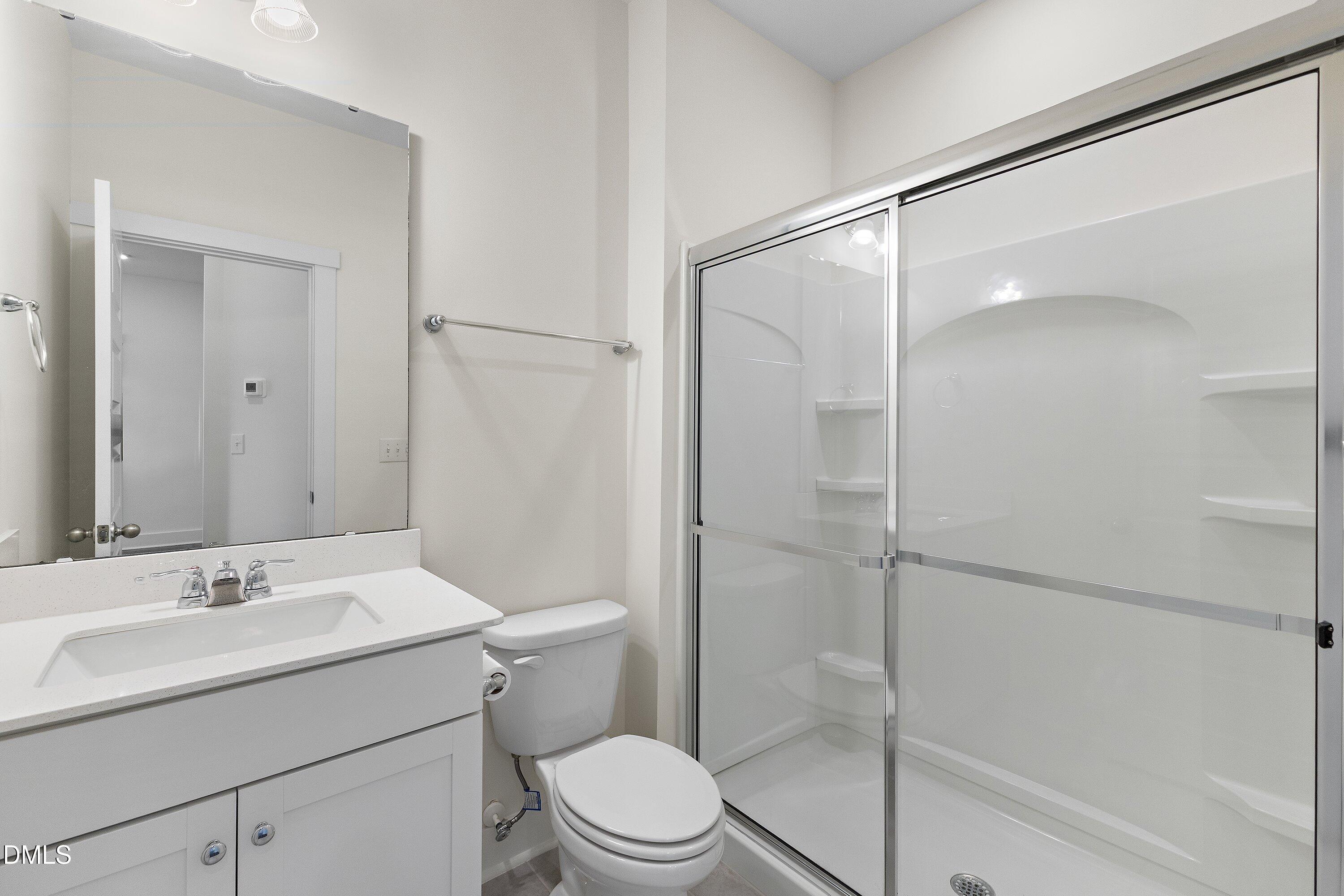 156 Sears Ridge Lane Morrisville, NC 27560 - Photo 17 of 49 a bathroom with a sink mirror vanity and toilet
