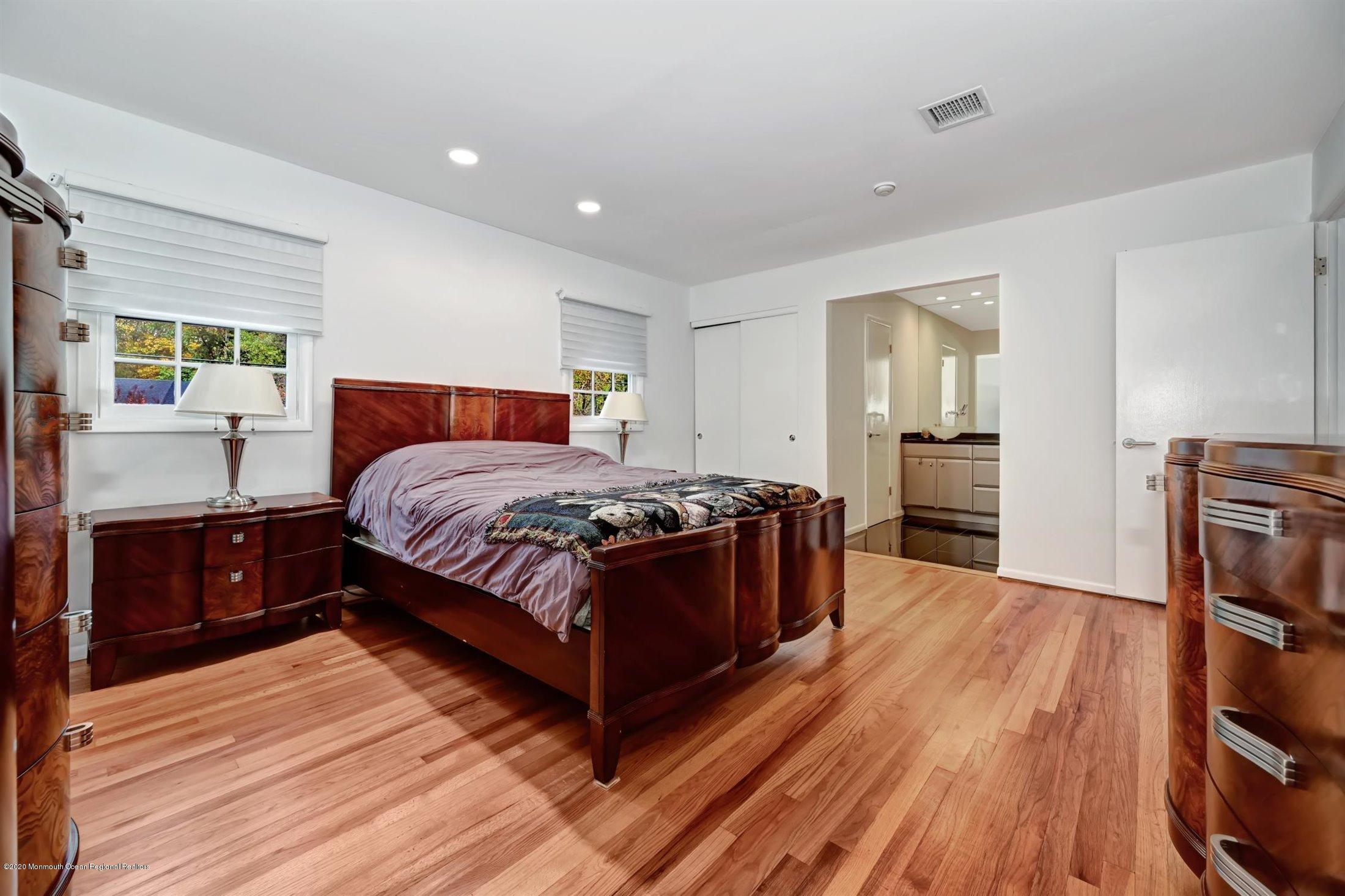 4 Canadian Woods Road Marlboro, NJ 07746 - Photo 14 of 33 a bedroom with a bed and wooden floor